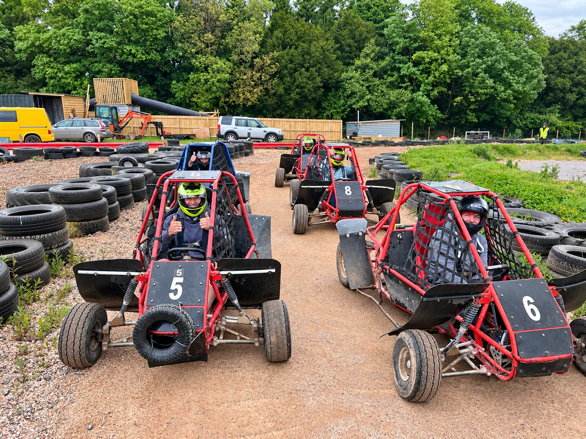 Helmeted drivers lined up in red and blue off-road karts at Exeter Karting